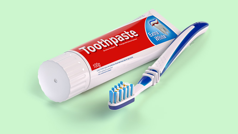 Spazzolino da denti e tubo di dentifricio isolato su sfondo bianco. 